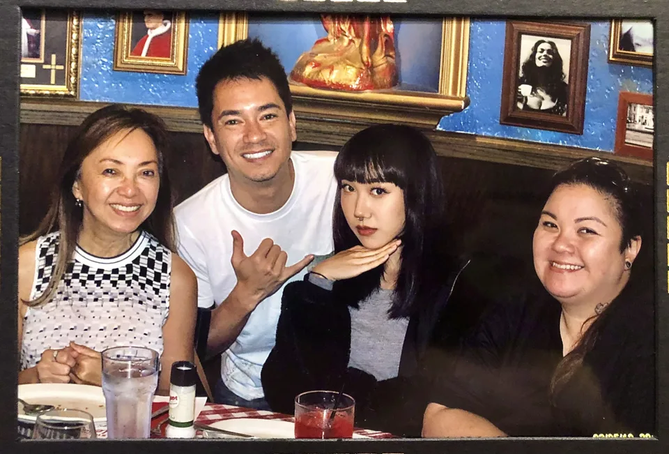 four at booth shaka sign smiling